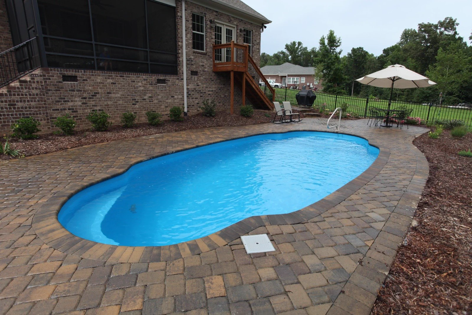 Fiberglass pool with paver coping and patio